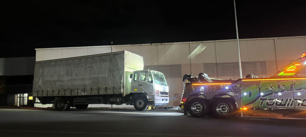 Kenworth prime mover being towed in Brisbane by Delta Heavy Towing